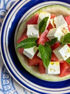 watermelon feta salad zoomed in with mint leaves and drizzled olive oil 