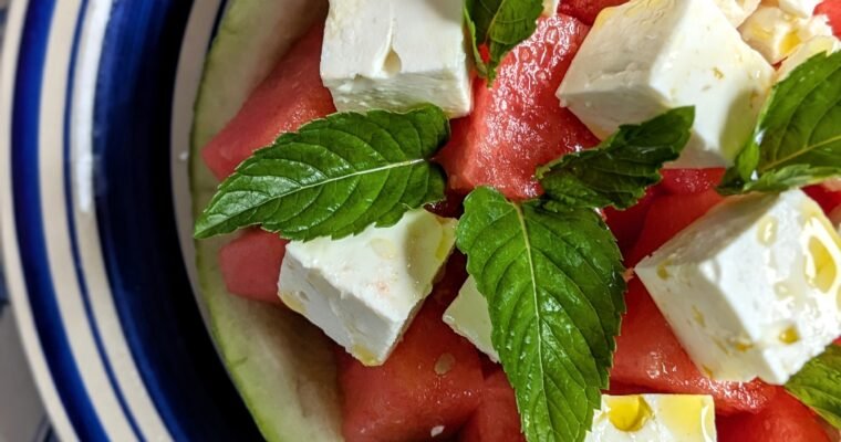 a beautiful Greek watermelon feta salad with mint leaves.