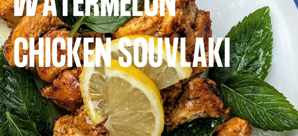a plate of our watermelon chicken souvlaki with lemon slices and mint leaves.
