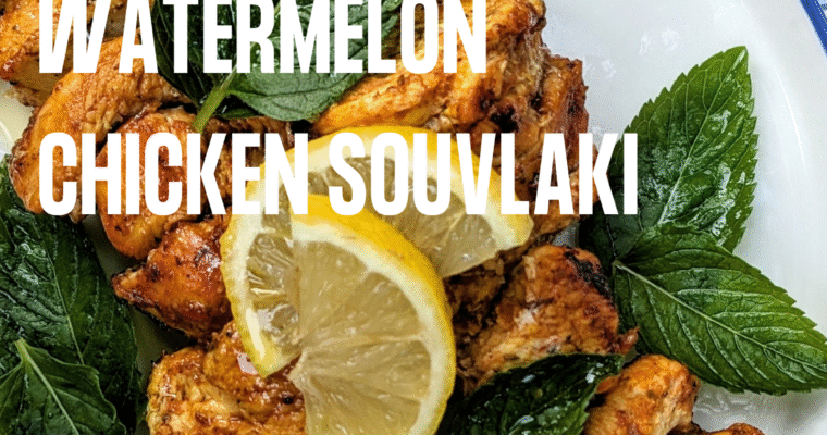 a plate of our watermelon chicken souvlaki with lemon slices and mint leaves.