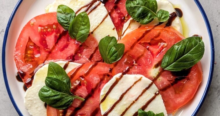 caprese salad served on a blue and white plate
