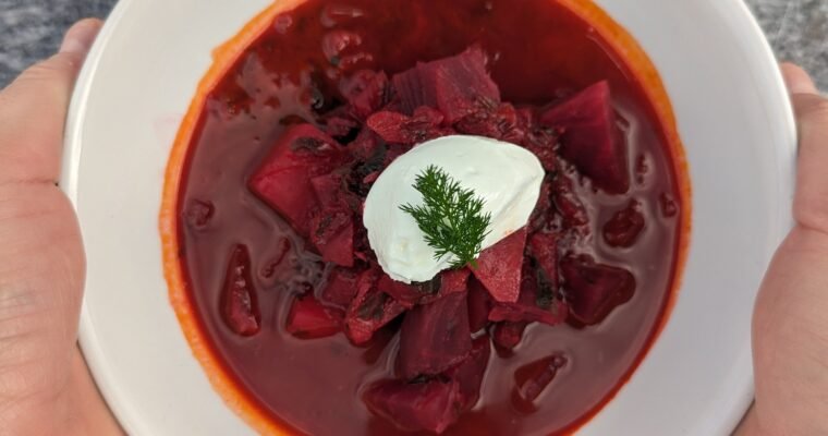 Borcht soup served with fresh sour cream and dill